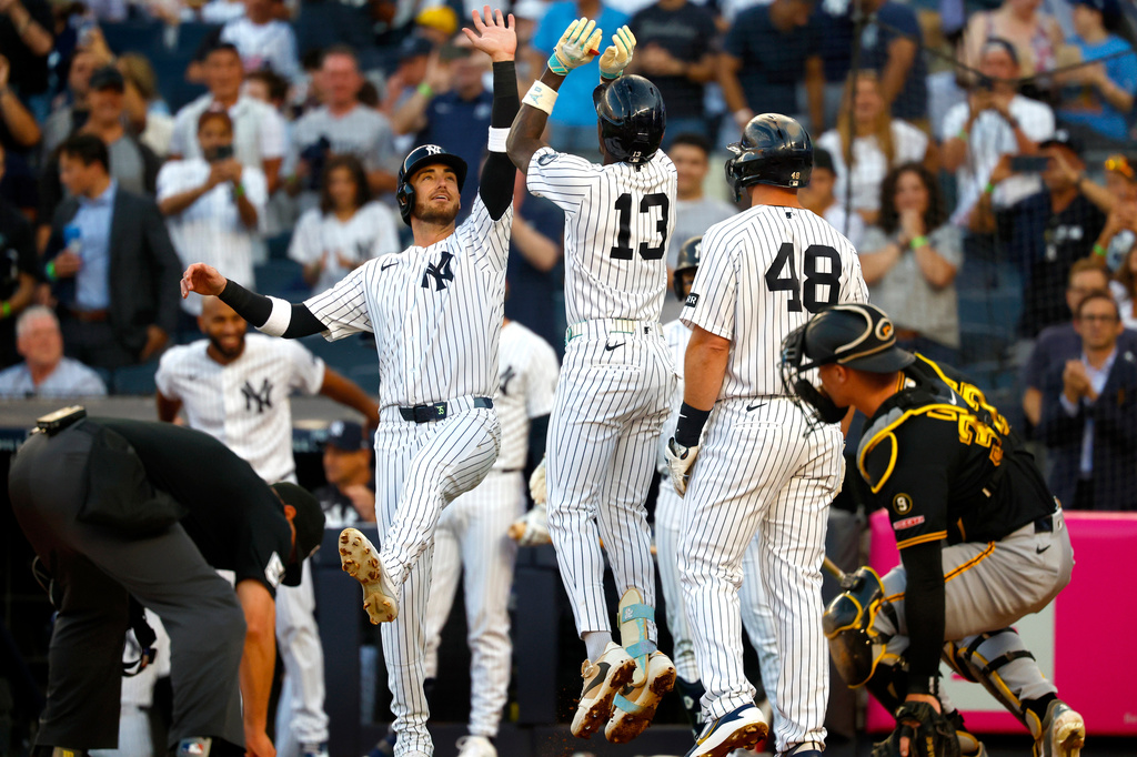 New York Yankees' Cody Bellinger, center left, and Jazz Chisholm Jr. (13) celebrate after Chisholm's home run against the Pittsburgh Pirates during the first inning of a baseball game, Monday, July 20, 2026, in New York. (AP Photo/Noah K. Murray)