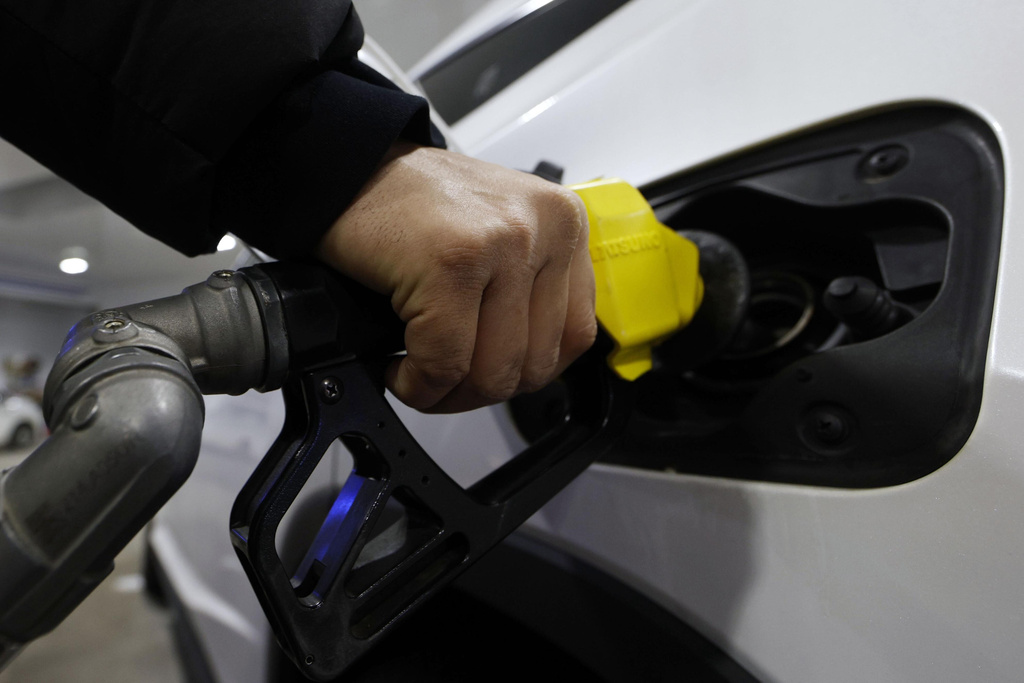 A customer fills up a fuel tank of a vehicle at a gas station in Tokyo, on March 12, 2026. (Suo Takekuma/Kyodo News via AP)