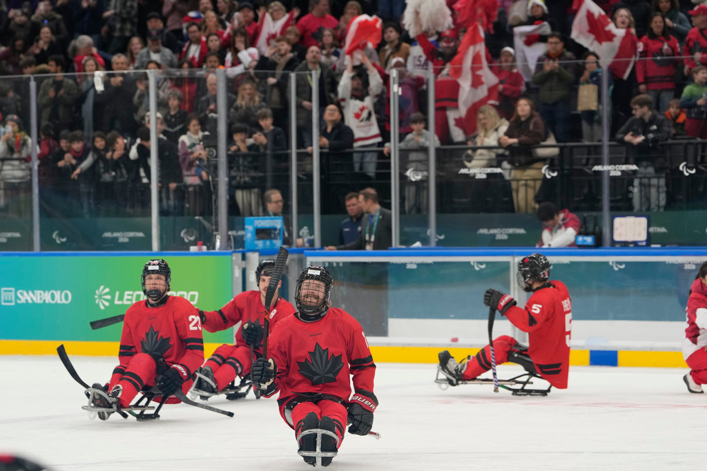 Canada players celebrate after winning a semifinal hockey match between against China at the 2026 Winter Paralympics, in Milan, Italy, Friday, March 13, 2026. (AP Photo/Luca Bruno)