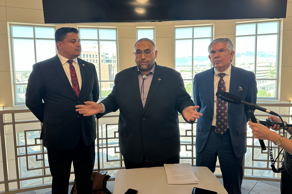 Attorney Jacob Candelaria, center, and clients Duke Rodriguez, right, and Zachary Anaya answer questions about their challenge of New Mexico's universal childcare program following a court hearing in Albuquerque, New Mexico, on Thursday, June 11, 2026. (AP Photo/Savannah Peters)
