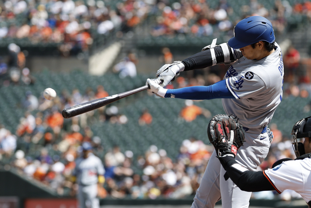 Los Angeles Dodgers' Shohei Ohtani hits a home run off Baltimore Orioles pitcher Tomoyuki Sugano during the first inning of a baseball game, Sunday, Sept. 7, 2025, in Baltimore. (AP Photo/Terrance Williams)