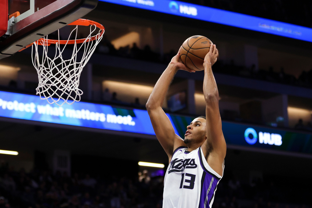 Sacramento Kings forward Keegan Murray dunks the ball during the first half of an NBA basketball preseason game against the Toronto Raptors, Wednesday, Oct. 8, 2025, in Sacramento, Calif. (AP Photo/Scott Marshall)