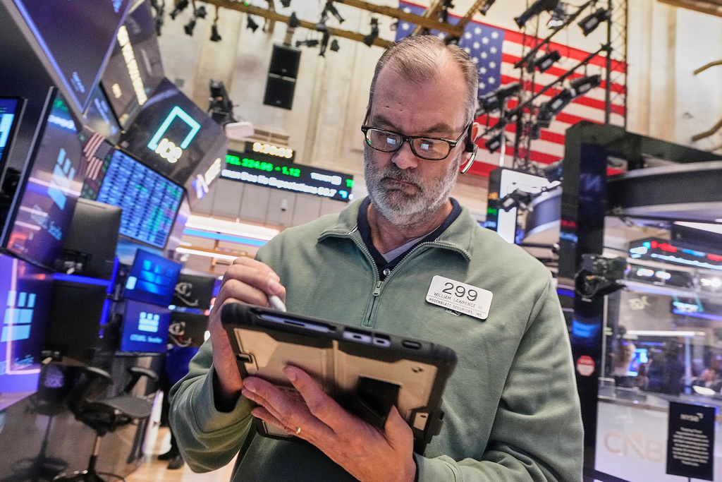 Trader William Lawrence works on the floor of the New York Stock Exchange, Monday, Jan. 26, 2026. (AP Photo/Richard Drew)