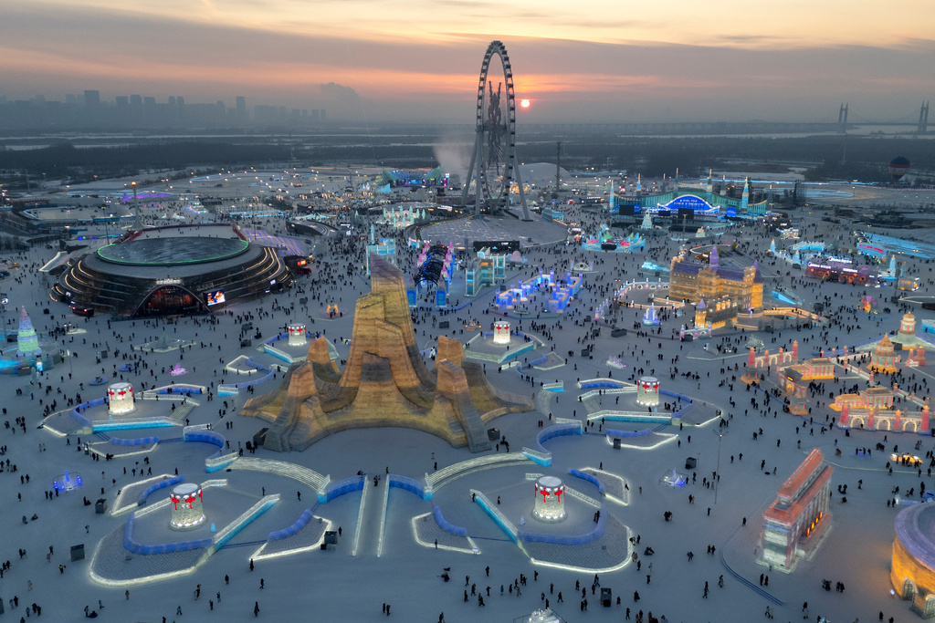 Attendees take in the sights at the annual Ice and Snow Festival held in Harbin in northeastern China's Heilongjiang province, Saturday, Jan. 3, 2026. (AP Photo/Ng Han Guan)