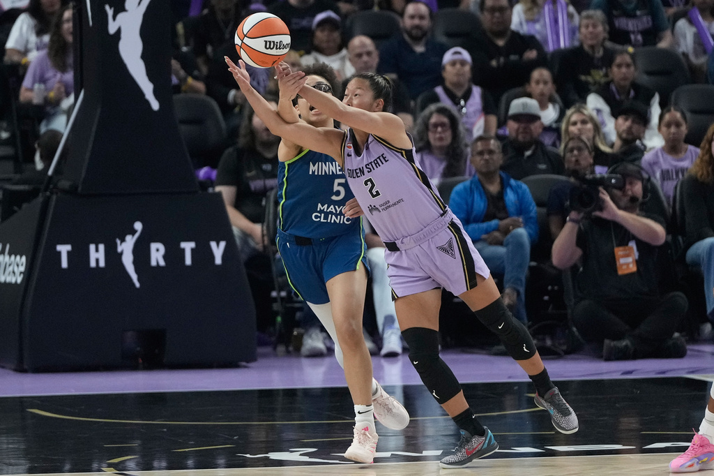 Golden State Valkyries guard Kaitlyn Chen (2) reaches for the ball against Minnesota Lynx guard Olivia Miles (5) during the first half of a WNBA basketball game in San Francisco, Wednesday, Aug. 19, 2026. (AP Photo/Jeff Chiu)
