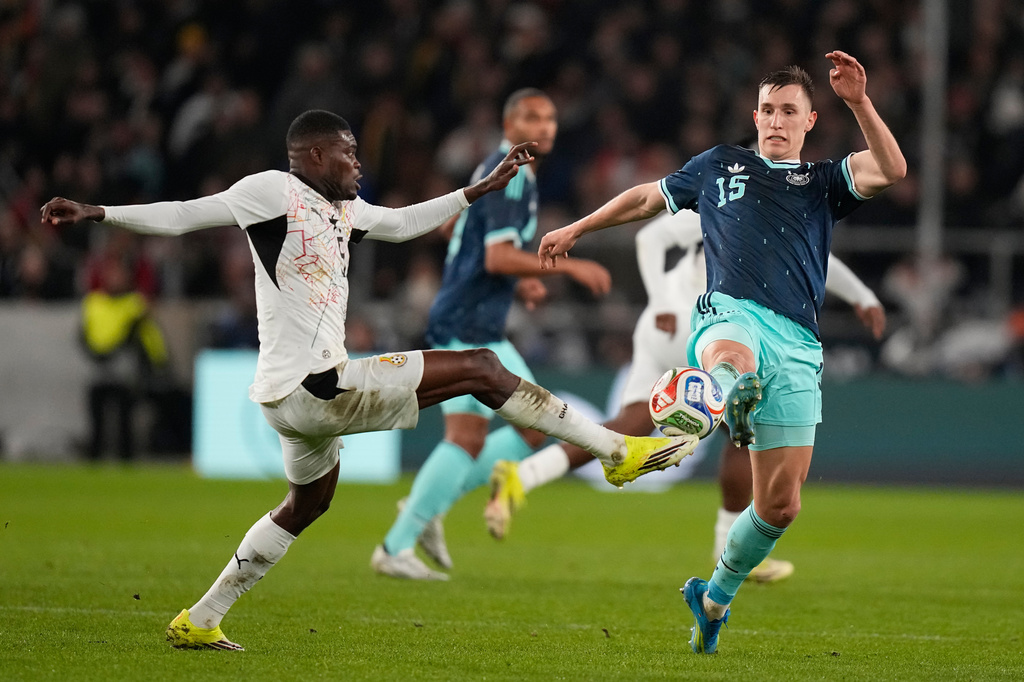 FILE -Thomas Partey of Ghana and Nico Schlotterbeck of Germany challenge for the ball during an international friendly soccer match between Germany and Ghana in Stuttgart, Germany, March 30, 2026. (AP Photo/Matthias Schrader, File)