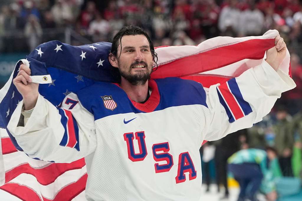 FILE - United States' Connor Hellebuyck (37) celebrates after defeating Canada during a men's ice hockey gold medal game between Canada and the United States at the 2026 Winter Olympics in Milan on Feb. 22, 2026. (AP Photo/Hassan Ammar, File)