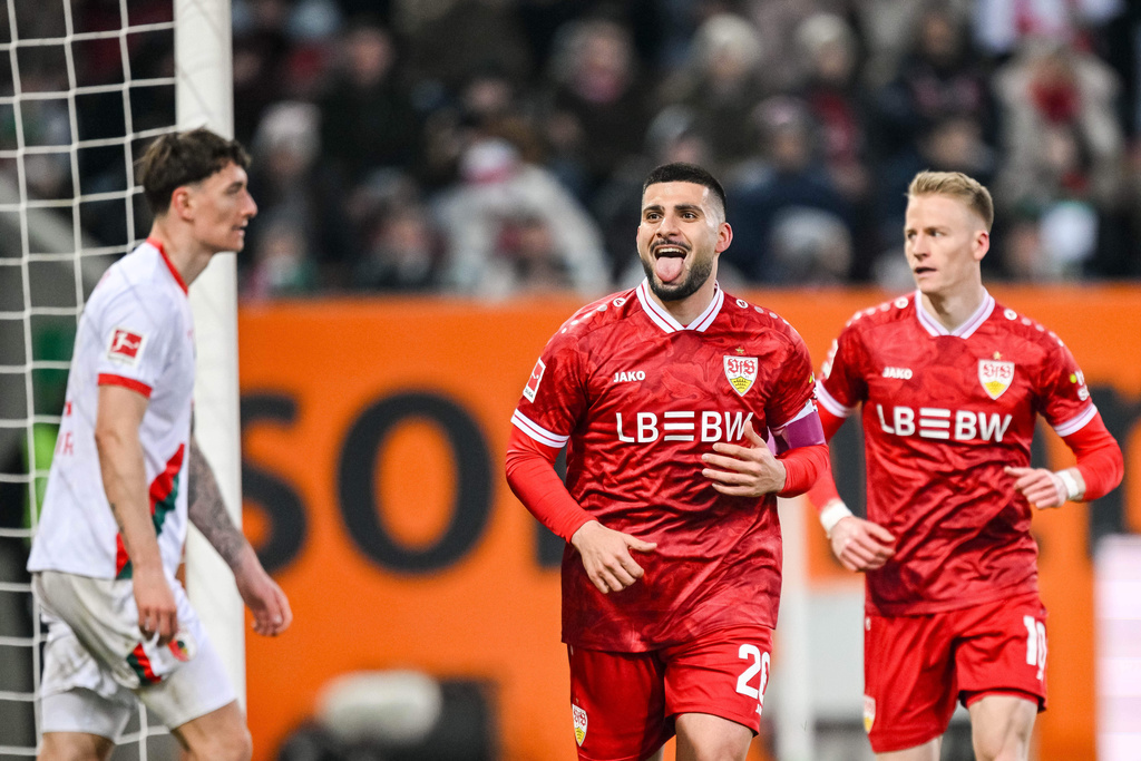 Stuttgart's Deniz Undav, center, celebrates after scoring his side's fourth goal during the German Bundesliga soccer match between FC Augsburg and VfB Stuttgart in Augsburg, Germany, Sunday, March 22, 2026. (Harry Langer/dpa via AP)
