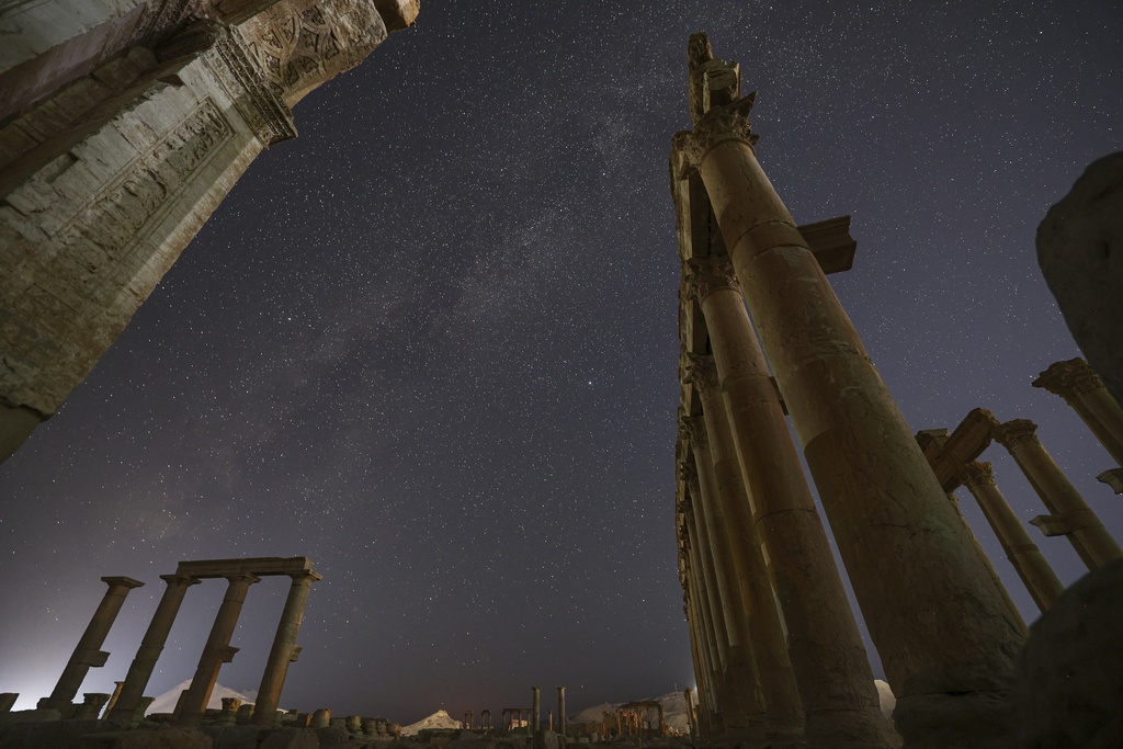 The entrance to the Roman Theater precinct, in the ruins of the ancient city of Palmyra, is seen under a star-studded sky in Syria, early Thursday, Aug. 28, 2025. (AP Photo/Ghaith Alsayed)