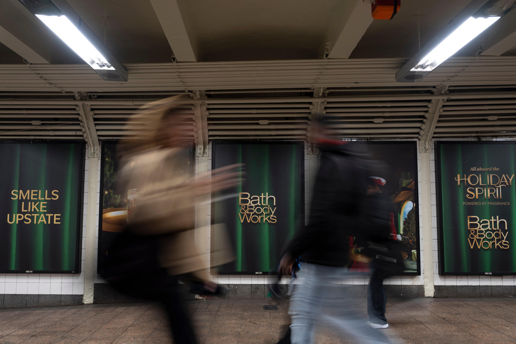 People walk past the posters promoting the campaign by Bath & Body Works at Grand Central Terminal, Wednesday, Nov. 19, 2025, in New York. (AP Photo/Yuki Iwamura)