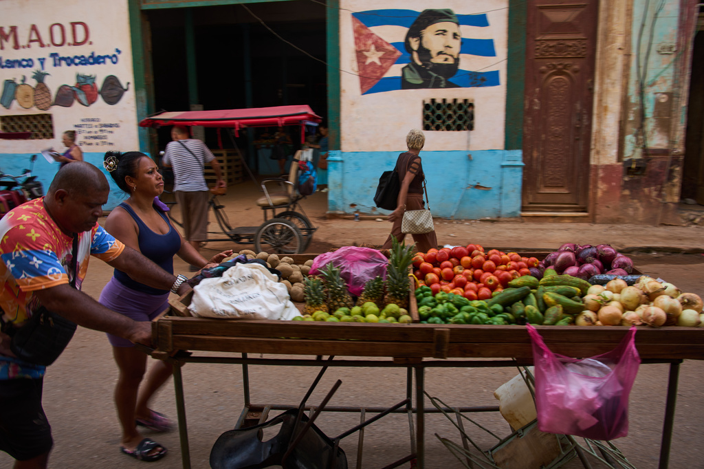 Street vendors push their cart of vegetables past a mural of Fidel Castro in Havana, Cuba, Wednesday, Aug. 12, 2026. (AP Photo/Ramon Espinosa)