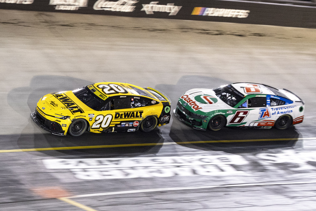 Christopher Bell (20) leads Brad Keselowski (6) during a NASCAR Cup Series auto race, Saturday, Sept. 13, 2025, in Bristol, Tenn. (AP Photo/Wade Payne)