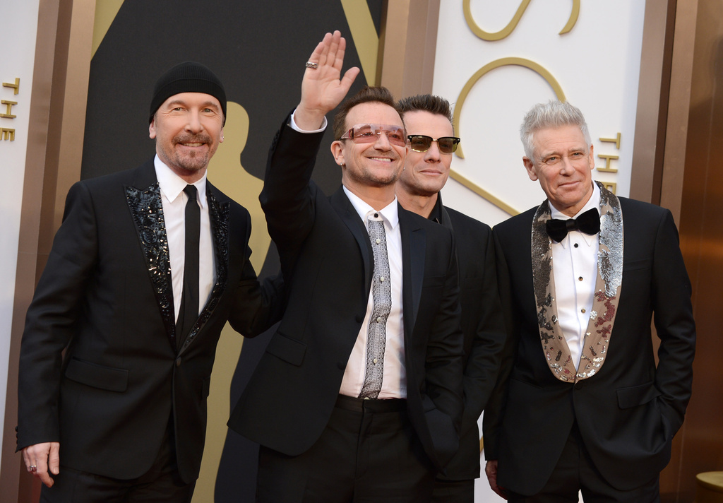 FILE - The Edge, from left, Bono, Larry Mullen, Jr., and Adam Clayton of U2 appear at the Oscars in Los Angeles on March 2, 2014. (Photo by Jordan Strauss/Invision/AP, File)