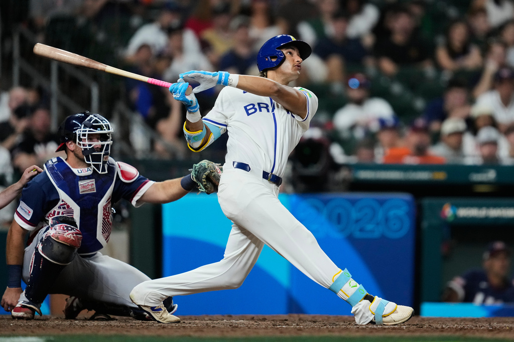 Brazil's Lucas Ramirez, right, hits a solo home run during the eighth inning of a World Baseball Classic game against the United States, Friday, March 6, 2026, in Houston. (AP Photo/Ashley Landis)