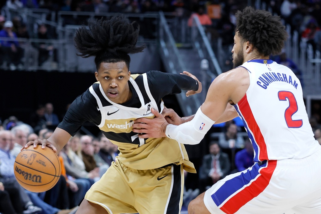 Washington Wizards guard Bub Carrington (7) drives against Detroit Pistons guard Cade Cunningham (2) during the first half of an NBA basketball game Thursday, Feb. 5, 2026, in Detroit. (AP Photo/Duane Burleson)
