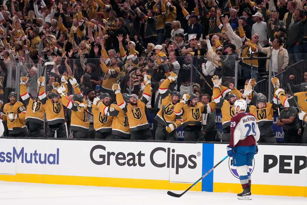 Members of the against the Vegas Golden Knights celebrate an empty net goal by Brett Howden as Colorado Avalanche center Nathan MacKinnon skates by during the third period in Game 3 of the Western Conference finals NHL hockey Stanley Cup playoff series Sunday, May 24, 2026, in Las Vegas. (AP Photo/Mark J. Terrill)