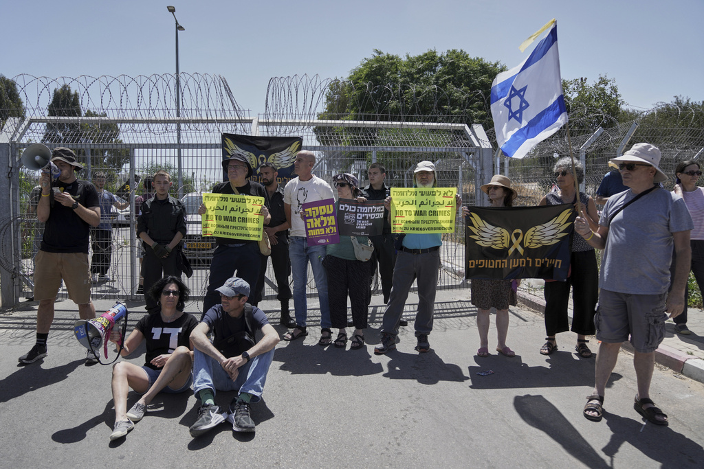 FILE - Relatives and supporters of Israeli soldier Daniel Yahalom, who was jailed for refusing to fight in Gaza, call for an end to the war outside the Beit Lid military base in central Israel on May 16, 2025. (AP Photo/Mahmoud Illean, File)