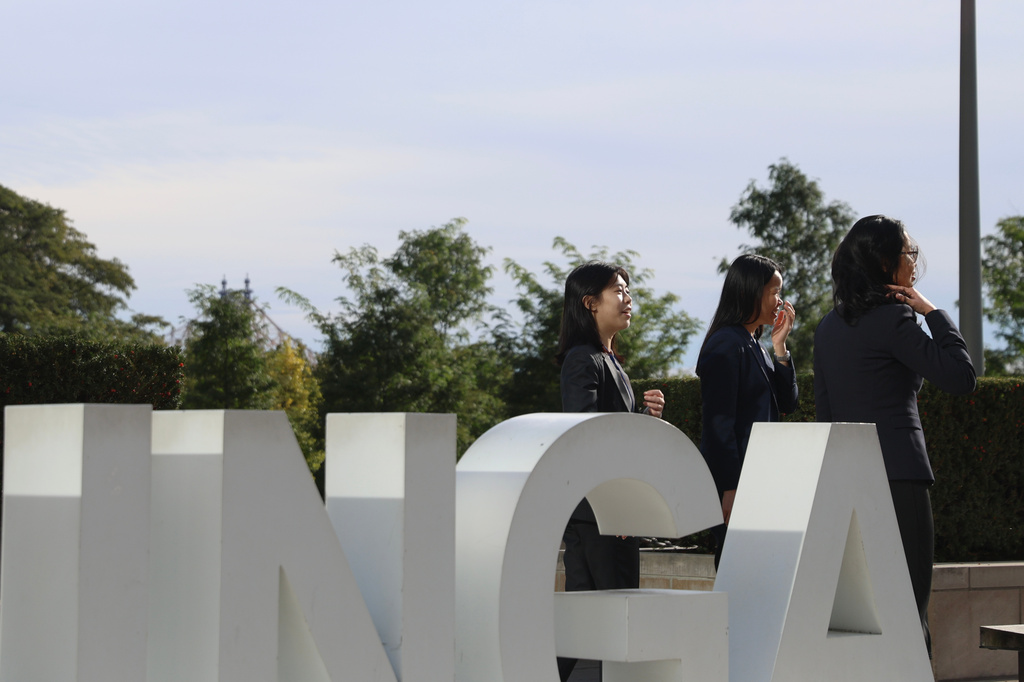 People pose for photos at United Nations headquarters during the 81st session of the United Nations General Assembly, Friday, Sept. 25, 2026. (AP Photo/Heather Khalifa)