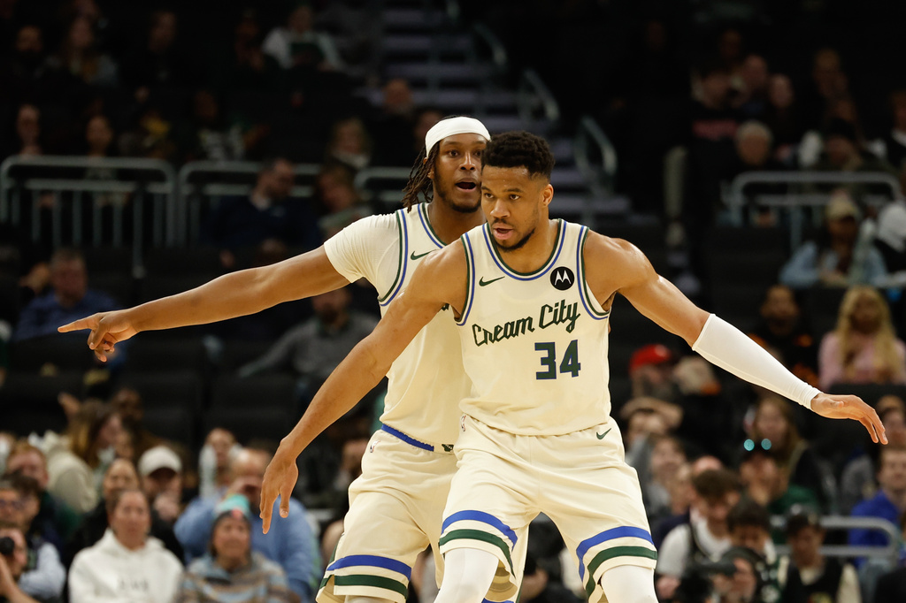Milwaukee Bucks forward Giannis Antetokounmpo (34) and Myles Turner play defense against the Atlanta Hawks during the first half of an NBA basketball game Wednesday, March 4, 2026, in Milwaukee. (AP Photo/Jeffrey Phelps)