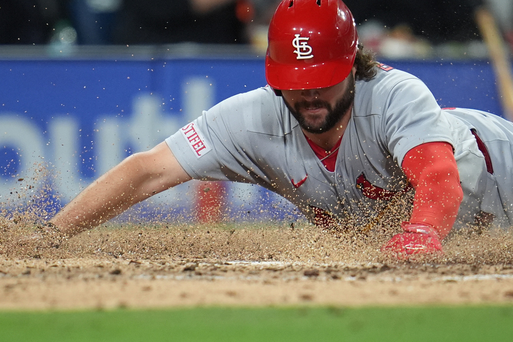 St. Louis Cardinals' Alec Burleson slides in to score from third off a sacrifice fly by Masyn Winn during the fifth inning of a baseball game against the San Diego Padres Friday, May 8, 2026, in San Diego. (AP Photo/Gregory Bull)
