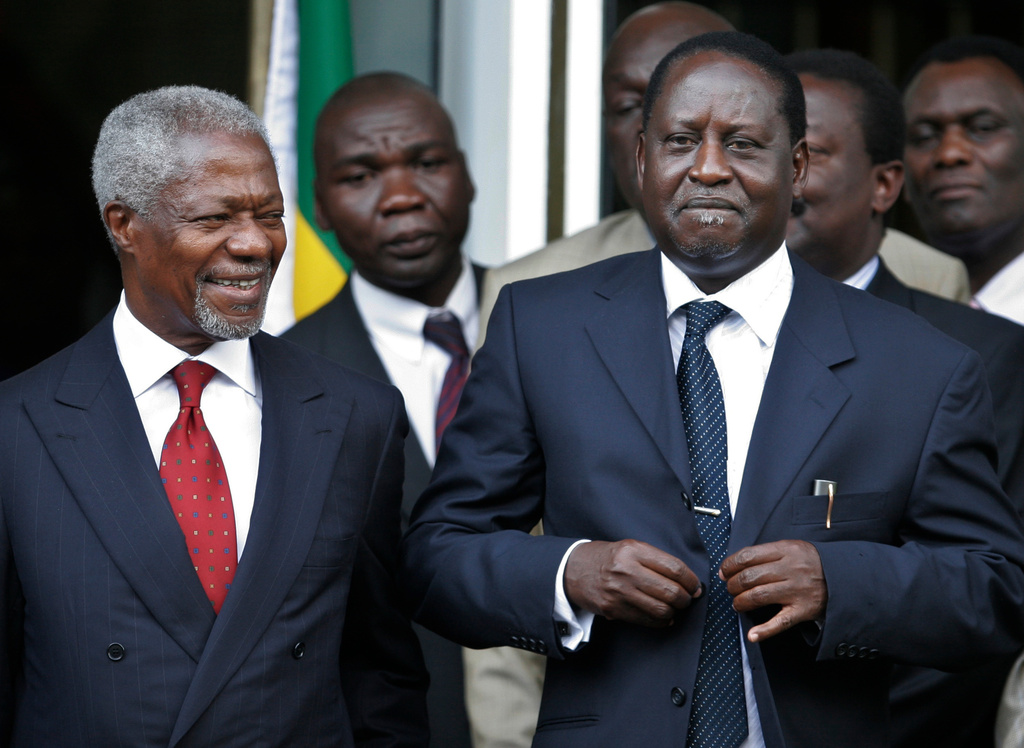 Former U.N. Secretary-General Kofi Annan, left, smiles as Kenyan opposition leader Raila Odinga looks on, after signing a power-sharing agreement with Kenyan President Mwai Kibaki in Nairobi, Kenya, Thursday, Feb. 28, 2008, after weeks of bitter negotiations on how to end the country's deadly post election crisis. (AP Photo/Khalil Senosi)