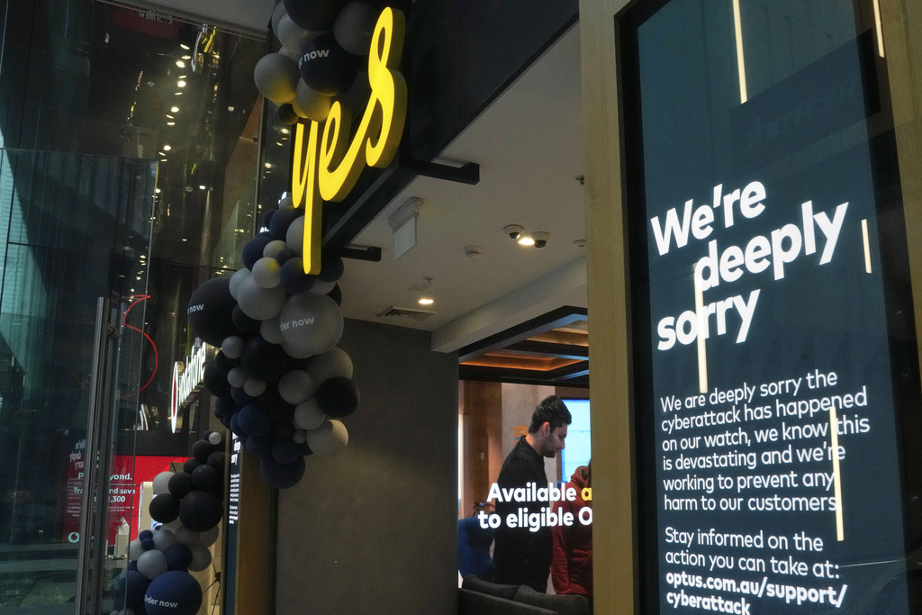 FILE - A customer waits for service at a Optus store in Sydney, Australia, Thursday, Oct. 7, 2021. (AP Photo/Mark Baker,File)
