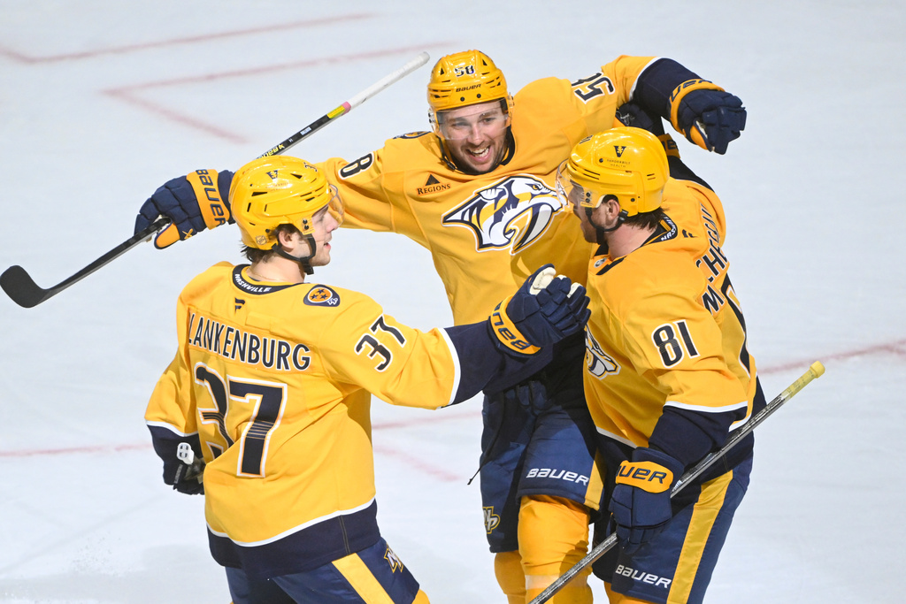 Nashville Predators center Jonathan Marchessault (81) celebrates after his goal with left wing Michael Bunting (58) and defenseman Nick Blankenburg (37) during the third period of an NHL hockey game against the Ottawa Senators, Thursday, Jan. 22, 2026, in Nashville, Tenn. (AP Photo/John Amis)