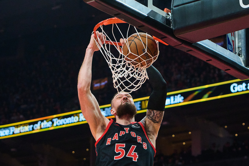 Toronto Raptors' Sandro Mamukelashvili (54) dunks against the Washington Wizards during first half NBA Cup basketball action in Toronto, Friday, Nov. 21, 2025. (Sammy Kogan/The Canadian Press via AP)