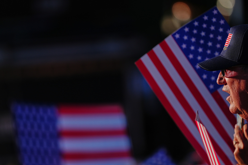 A person watches the stage before President Donald Trump speaks at the opening of the Great American State Fair on the National Mall, Wednesday, June 24, 2026, in Washington. (AP Photo/Julia Demaree Nikhinson)