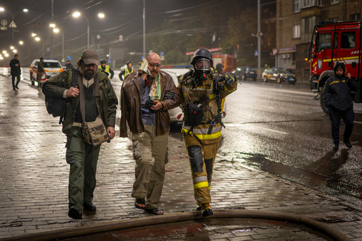 A rescuer helps an injured man after a Russian strike on a residential building in Kyiv, Ukraine, Friday, Oct. 10, 2025. (AP Photo/Dan Bashakov) A rescuer helps an injured man after a Russian strike on a residential building in Kyiv, Ukraine, Friday, Oct. 10, 2025. (AP Photo/Dan Bashakov)