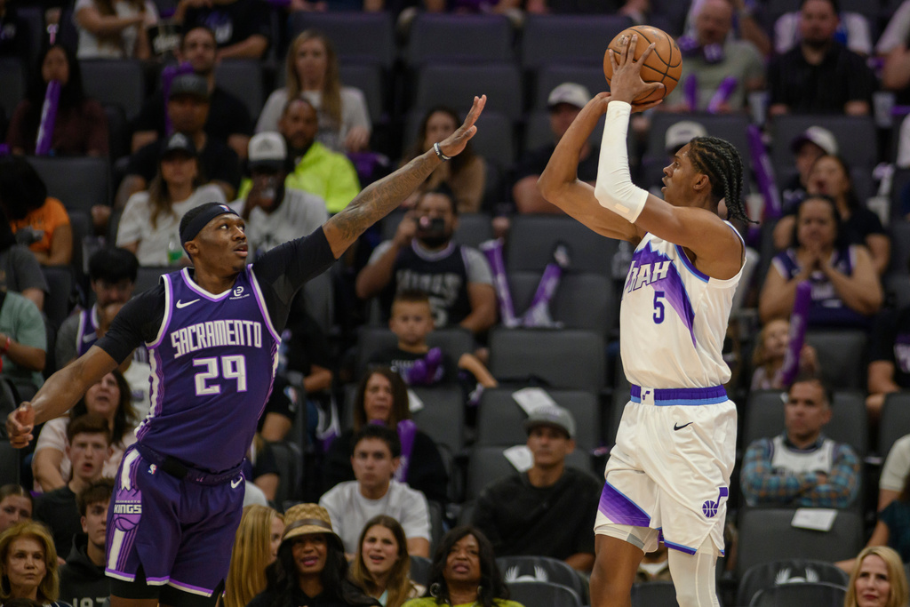 Utah Jazz forward Cody Williams (5) shoots over Sacramento Kings guard Daeqwon Plowden (29) during the second half of an NBA basketball game in Sacramento, Calif., Sunday, March 15, 2026. (AP Photo/Randall Benton)