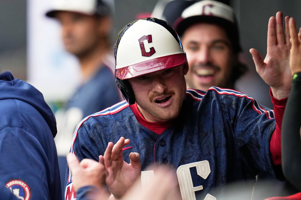 Cleveland Guardians' Kyle Manzardo celebrates in the dugout after scoring on a double hit by Kahlil Watson in the first inning of a baseball game against the Seattle Mariners in Cleveland, Friday, June 26, 2026. (AP Photo/Sue Ogrocki)