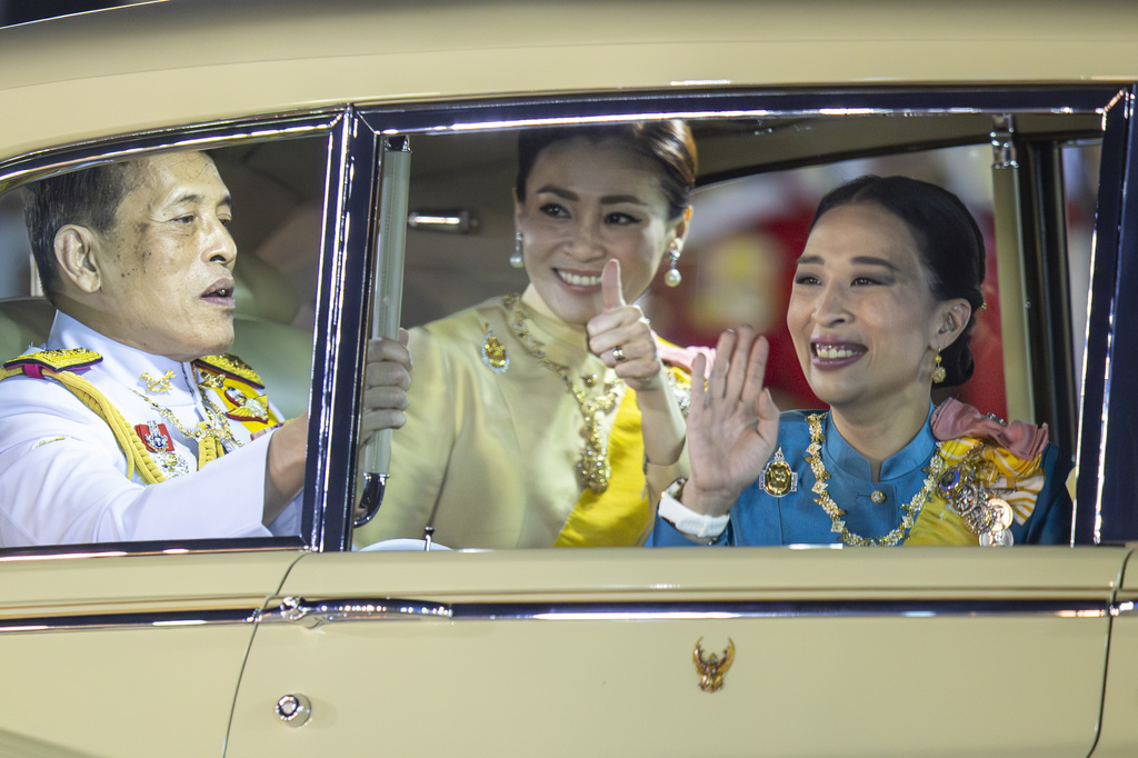 Thai King Maha Vajiralongkorn, from left, Queen Suthida and Princess Bajrakitiyabha Mahido wave to supporters in Bangkok, Thailand, May 5, 2020. (AP Photo/Wason Wanichakorn)