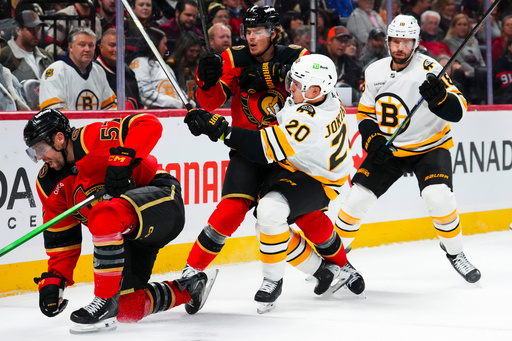 Ottawa Senators' Ridly Greig, center, hits Boston Bruins' Henri Jokiharju (20) during second-period NHL hockey game action in Ottawa, Ontario, Monday, Oct. 27, 2025. (Sean Kilpatrick/The Canadian Press via AP) Ottawa Senators' Ridly Greig, center, hits Boston Bruins' Henri Jokiharju (20) during second-period NHL hockey game action in Ottawa, Ontario, Monday, Oct. 27, 2025. (Sean Kilpatrick/The Canadian Press via AP)