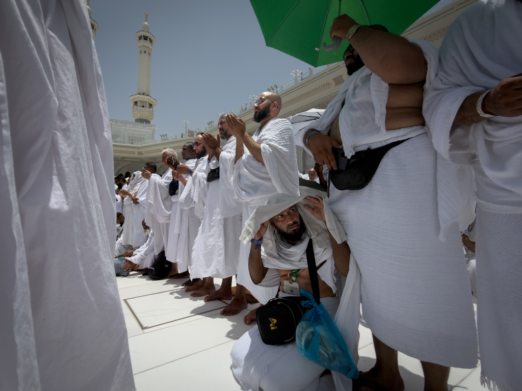 Muslim pilgrims pray in front of the Kaaba, the cubic building at the Grand Mosque, during the annual Hajj pilgrimage in the Muslim holy city of Mecca, Saudi Arabia, Thursday, May 21, 2026. (AP Photo/Altaf Qadri)