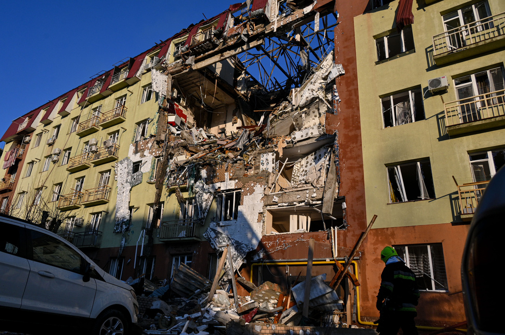 A rescue worker walks in front of residential building which was heavily damaged after a Russian strike in Odesa, Ukraine, Monday, April 6, 2026. (AP Photo/Michael Shtekel)