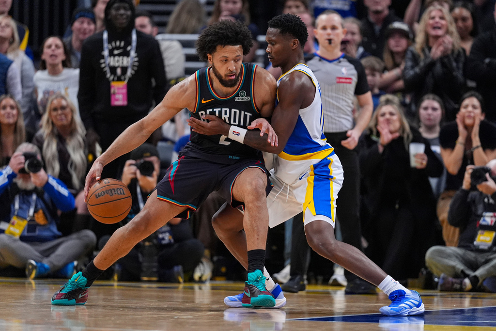 Detroit Pistons guard Cade Cunningham (2) drives on Indiana Pacers guard Bennedict Mathurin (00) during the second half of an NBA basketball game in Indianapolis, Monday, Nov. 24, 2025. (AP Photo/Michael Conroy)