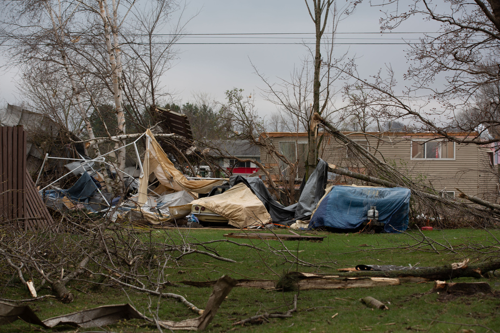 Debris and fallen tree limbs cover the ground after a severe storm that tore through the Upper Midwest on Friday, April 17, 2026, in Rochester, Minn. (Hollie Bennett Piotrowicz via AP)