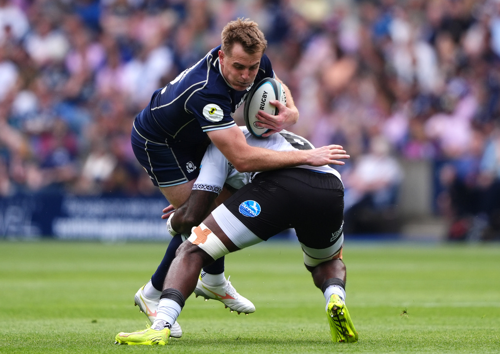 Scotland's Stafford McDowall, left, is tackled by Fiji's Pita Sowakula during the Nations Championship match between Scotland and Fiji, at Scottish Gas Murrayfield Stadium in Edinburgh, Scotland, Saturday July 18, 2026. (Andrew Milligan/PA via AP)
