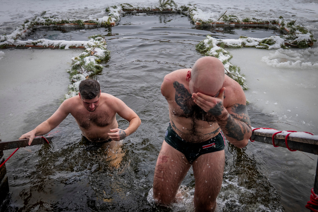 A veteran who lost his arm in Russia-Ukraine war, comes out of the icy water during celebrations of Epiphany in Kyiv, Ukraine, Tuesday, Jan. 6, 2026. (AP Photo/Dan Bashakov)