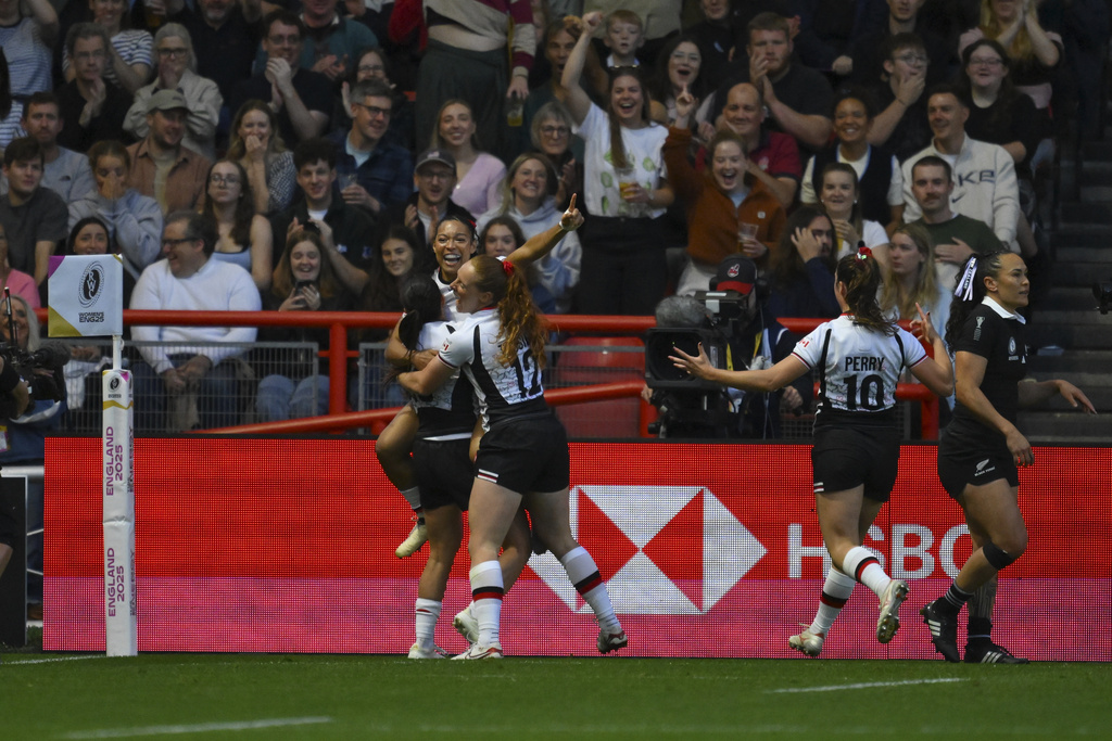 Canada's team players celebrate after scoring their first try during the Women's Rugby World Cup 2025 semifinal match between New Zealand and Canada in Bristol, England, Friday, Sept. 19, 2025.(AP Photo/Anthony Upton)