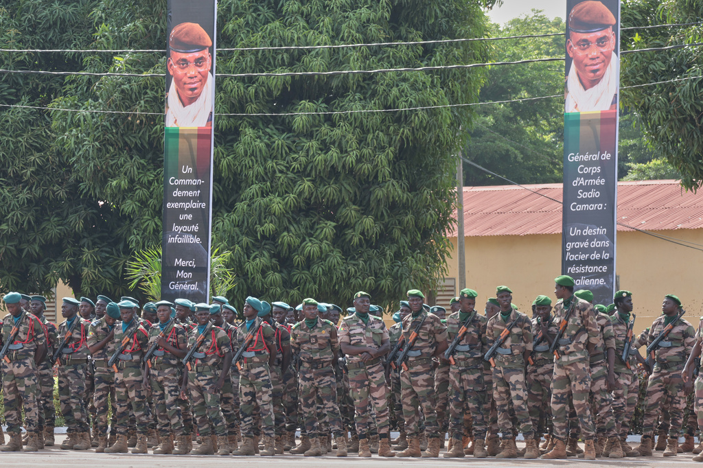 Soldiers wait for the start of the funeral for Mali's former defense minister Sadio Camara at the Military Engineering Parade Ground in Bamako, Mali, Thursday, April 30, 2026. (AP Photo/Boubacary Bocoum)
