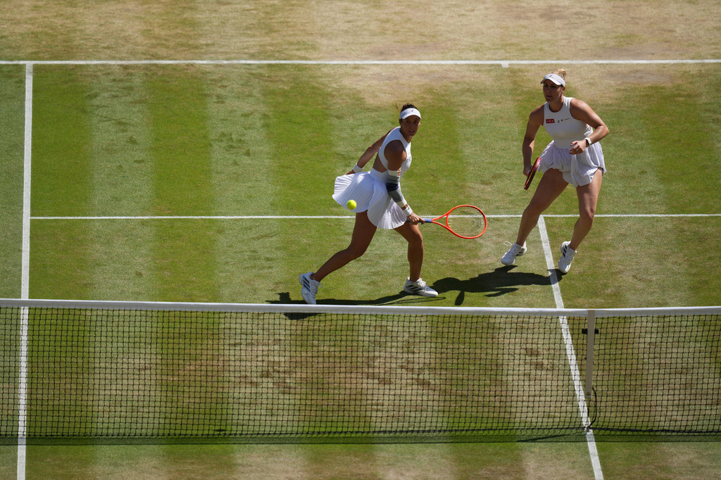 Luisa Stefani of Brazil, left, and Gabriela Dabrowski of Canada eye the ball after returning it to Guo Hanyu of China and Kristina Mladenovic of France in the women's doubles final at Wimbledon Tennis Championships in London, Sunday, July 12, 2026. (AP Photo/Kirsty Wigglesworth)