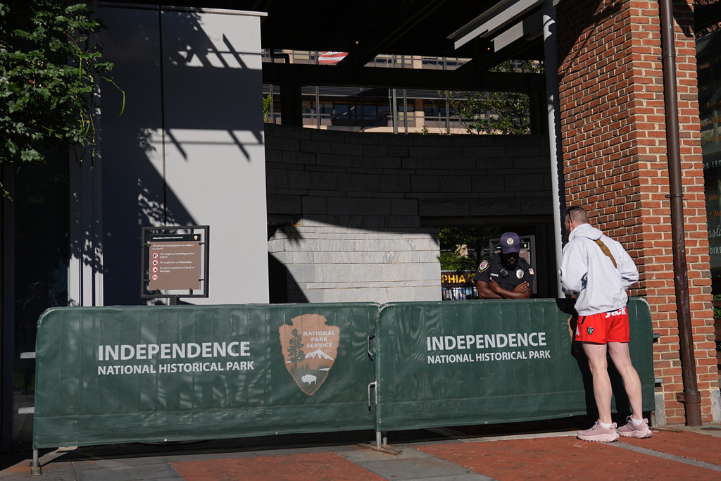 A man looks on in front of a barrier as Liberty Bell Center is closed due to a government shutdown, in Philadelphia, Wednesday, Oct. 1, 2025. (AP Photo/Matt Rourke)