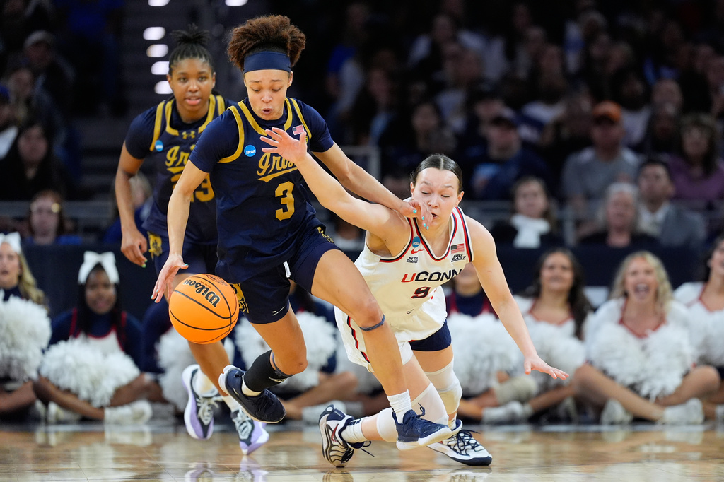 FILE - Notre Dame guard Hannah Hidalgo (3) steals the ball from UConn guard Kayleigh Heckel (9) during the second half in the Elite Eight of the NCAA college basketball tournament, March 29, 2026, in Fort Worth, Texas. (AP Photo/Tony Gutierrez, FIle)