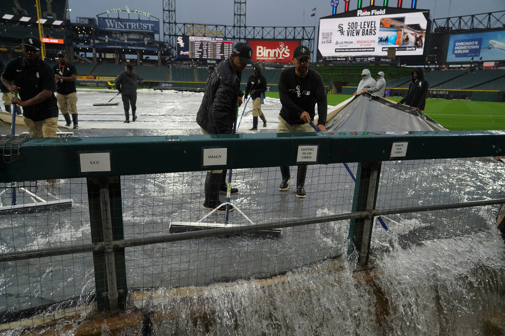 Grounds crew remove water from the field after severe thunderstorms came through the Chicago area before a baseball game between the Chicago White Sox and the Atlanta Braves, Wednesday, June 10, 2026, in Chicago. (AP Photo/David Banks)