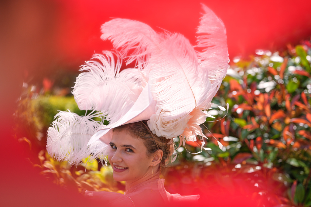 Racegoers pose for photographs on the first day of the Royal Ascot horse race meeting in Ascot, England, Tuesday, June 16, 2026.(AP Photo/Kin Cheung)