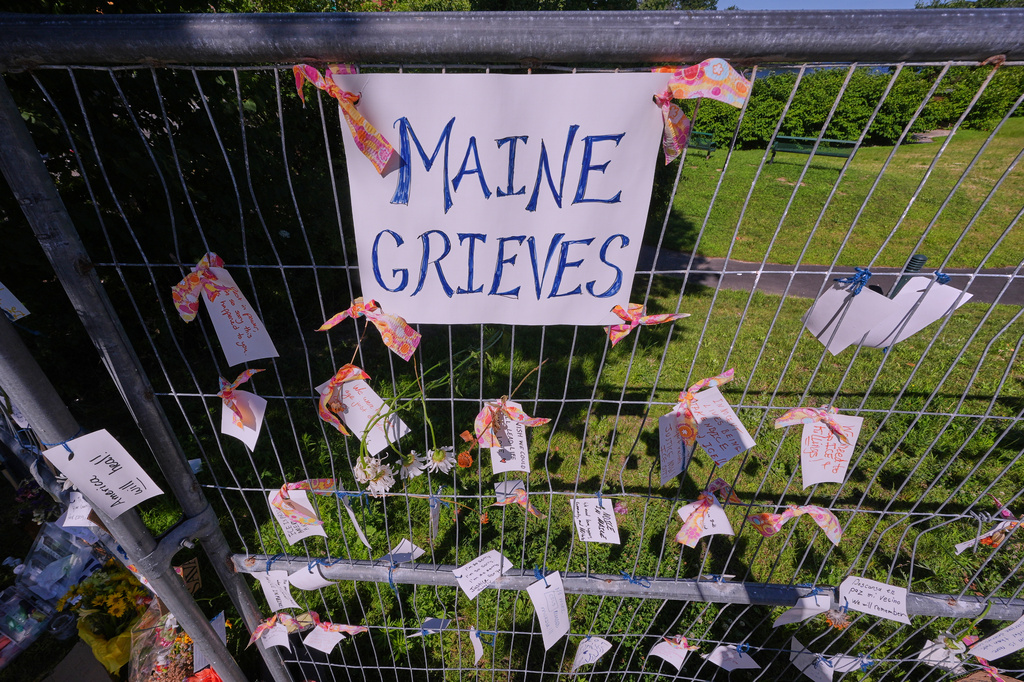 Notes of community support and sorrow are hung from a fence during a vigil for Johan Sebastian Duran Guerrero, a Colombian national who was shot and killed by an ICE agent, Friday, July 17, 2026, in Biddeford, Maine. (AP Photo/Charles Krupa)