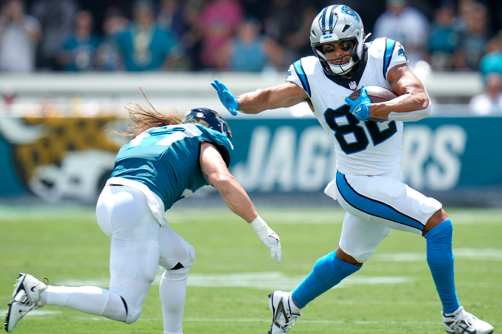 Carolina Panthers tight end Tommy Tremble (82) runs against Jacksonville Jaguars tight end Patrick Herbert (47) during the first half of an NFL football game, Sunday, Sept. 7, 2025, in Jacksonville, Fla. (AP Photo/John Raoux)