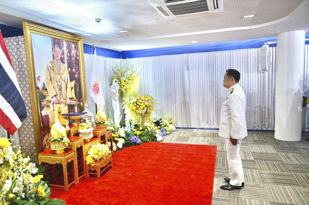 In this photo released by the Thai government spokesman office, Thailand's new Prime Minister Anutin Charnvirakul pays respect to a portrait of King Maha Vajiralongkorn, as he receives the royal endorsement ceremony at Bhumjai Thai party Headquarters in Bangkok, Thailand, Sunday, Sept. 7, 2025. (Thai government spokesman office via AP)